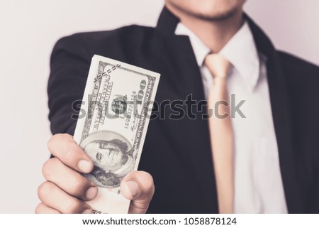 Businessman with money in studio . Business concept