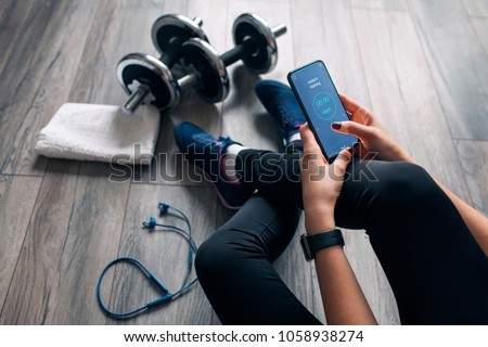 girl uses fitness app Royalty-Free Stock Photo #1058938274