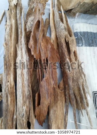 Agarwood, aloeswood or gharuwood is a fragrant dark resinous wood used in incense, perfume, and small carvings. 