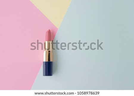Flat lay of creative female cosmetic for pink lipstick on the colorful background with copy space