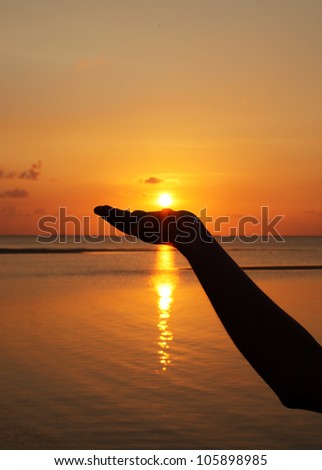 close up woman hand holding sun in hand