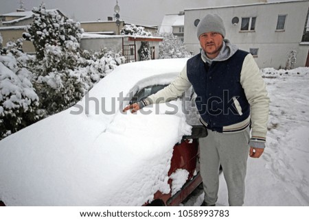 Removing Snow from the Car windshield