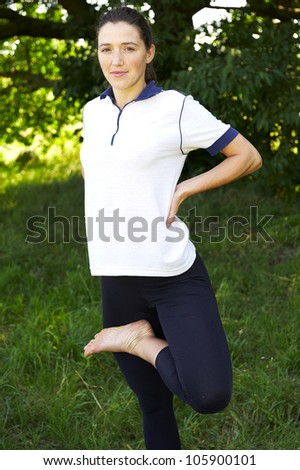 Beautiful sport woman doing stretching fitness exercise outdoor