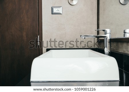 Faucet and sink decoration in bathroom interior
