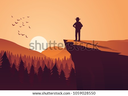man take adventure in jungle,stand on cliff look to the sun in around with pine forest Royalty-Free Stock Photo #1059028550