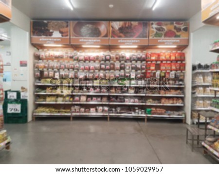 Shelf in the supermarket that selling many ingredients for cooking. It's a blurred picture.