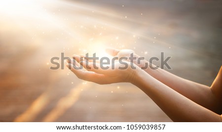 Woman hands praying for blessing from god on sunset background 