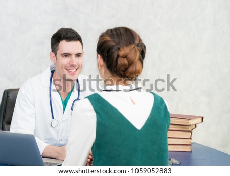 Male doctor explaining to patient at consulting room with computer,Doctor showing application while consulting patient,Disease prevention and ward round reception for prescribe remedy,Empathy,