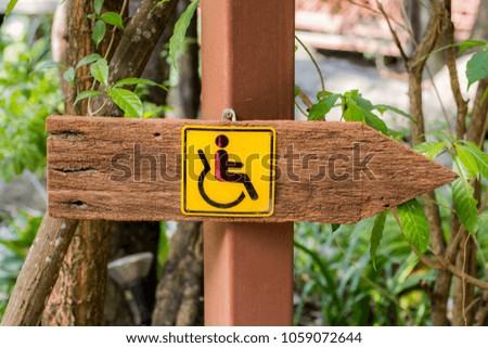 Wooden sign for the handicapped.