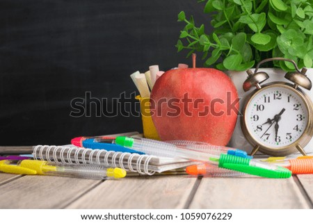 School supplies on the background of a school board with a blank space