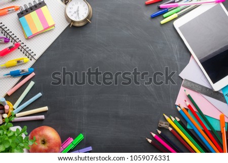 On the school board, school supplies. With an empty place for inscription or advertising.