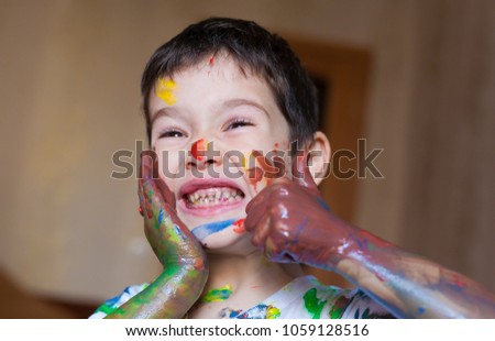 Beautiful little brunet hair boy, has happy fun smiling face, brown eyes, white t-shirt. Painted in skin hands. Child portrait. Creative concept. Water colors.  Close up