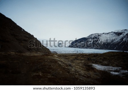A glacier in Iceland between some mountain ranges.