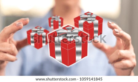 Gift concept between hands of a woman in background
