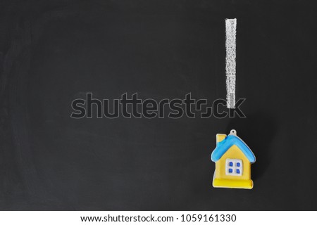 miniature model house and exclamation mark with copy space