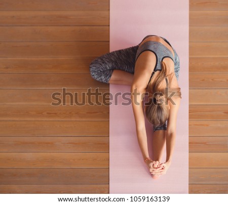 Young woman practicing gymnastics from above Royalty-Free Stock Photo #1059163139