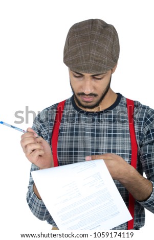 young man wearing a hat and holding a pen and paper write something in it, isolated on white background