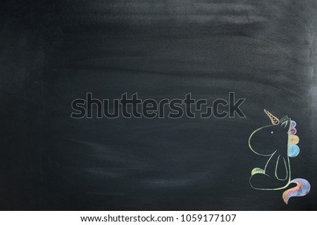 A colored unicorn painted chalk on a blackboard.