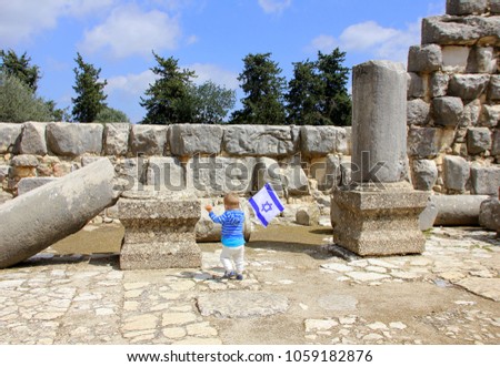 boy with the flag of Israel in the ancient city
