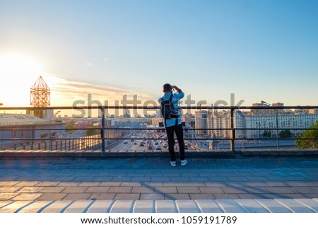 Photographer taking picture above Moscow cityscape with Third Transport Ring road and modern architecture of Moscow City Business Center, Russia.
