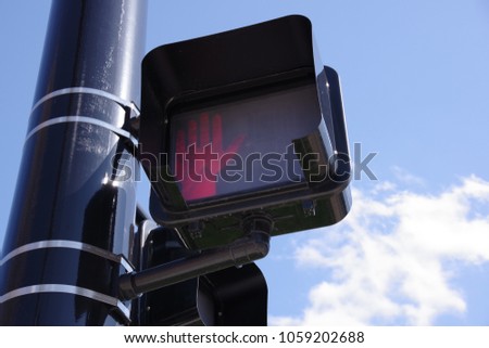 Pedestrian crossing traffic light-red light upraised hand signal indicator for do not walk