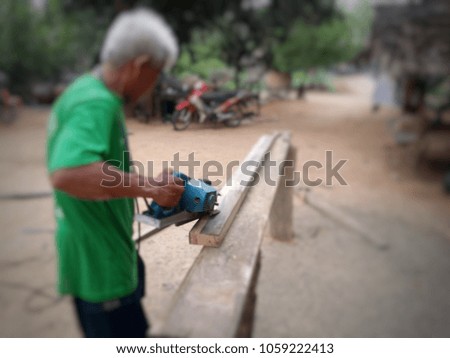 Blurred photo.The carpenter is working without wearing a protective suit.