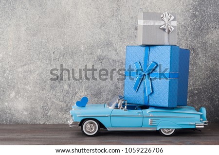 Father's day concept. A toy car with gifts, heart, 19th of July on wooden background. Copy space for Fathers day greeting card. Royalty-Free Stock Photo #1059226706