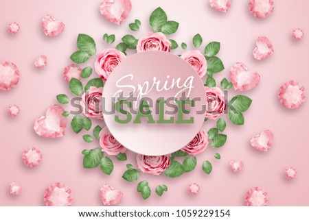 Inscription Spring sale, Pink roses and green leaves with a luminous pink background. Spring background. flat lay, copy space, Mixed media, top view.