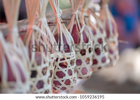 Wicker round bamboo basket and purple egg inside, small depth of field.