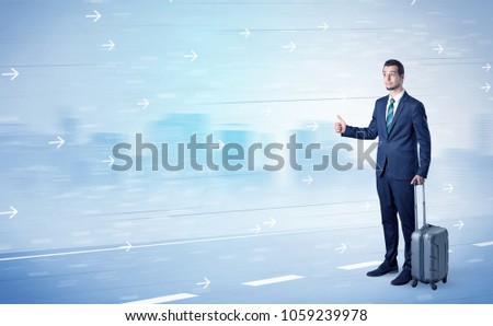 Young businessman hitchhiking near the city with arrows around concept