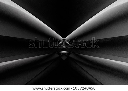 Abstract architecture with sloped girders refracted by small glass prism in center of composition. Black and white photo of modern building in darkness. Distortion and chiaroscuro effect background. 

