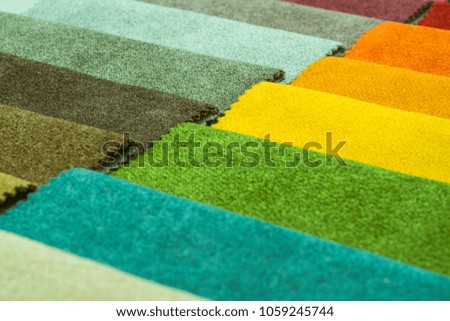 Close up view of a beautiful abstract art background of detail bright colorful fabric palette texture samples.
