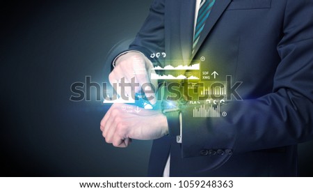 Businessman wearing smartwatch with graphics and charts on it.