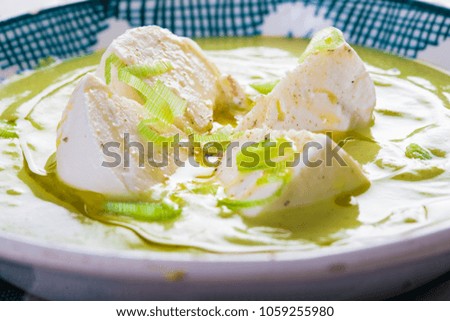 Cream of zucchini soup with apple, spring onion and mozzarella cheese