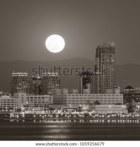 San Diego downtown skyline and full moon over water at night