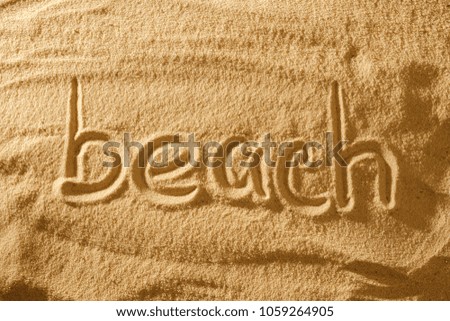 Word beach in the sand against the sea sun. concept symbol of holiday.