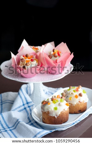 Easter bread with white icing, candied fruits and nuts.