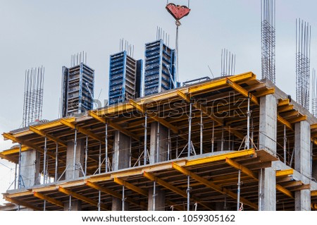 A fragment of construction work site and high rise crane building