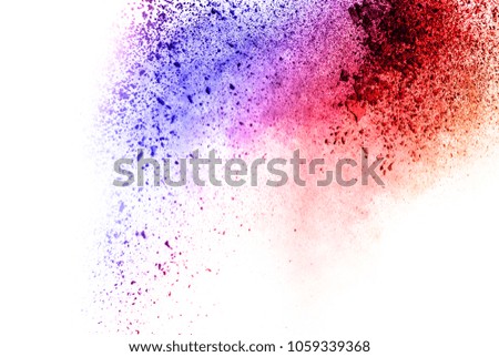 Abstract multi color powder explosion on white background. Freeze motion of color dust particles splash. Painted Holi