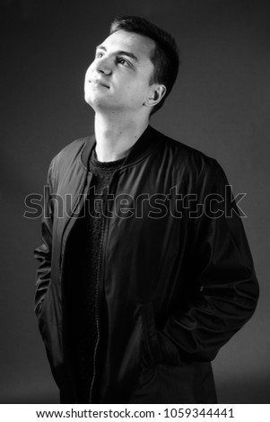 Studio shot of young handsome man wearing stylish clothes in black and white