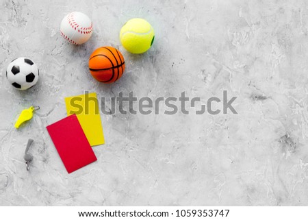 Sport judging concept. Sport game referee. Tactic plan for game, balls, red and yellow cards, whistle on stone background top view