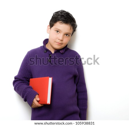 child with book in white wall