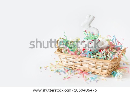 Russian Orthodox Easter. White and pink background. Easter cake, Easter bunny, colored eggs.