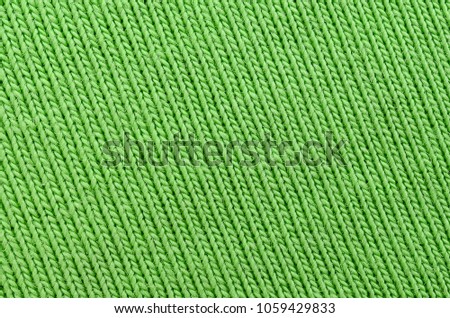 The texture of the fabric is bright green. Material for making shirts and blouses