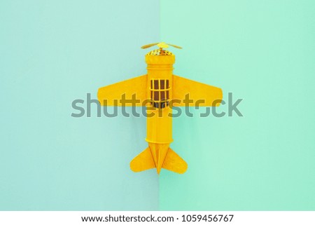 top view photo of toy airplanover double colorful background. Concept of imagination, creativity, dreaming and childhood