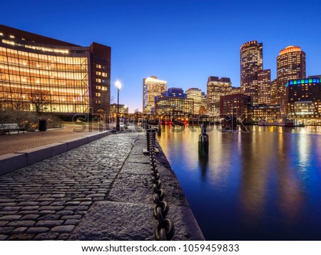 the architecture of Boston in Massachusetts, USA at night as seen from the Fan Pier.