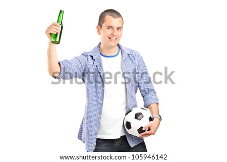 An euphoric male fan holding a football and beer bottle isolated on white background