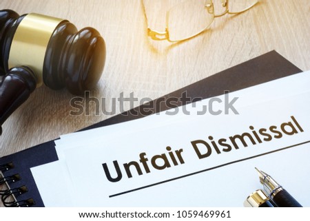 Documents unfair dismissal and gavel in a court. Royalty-Free Stock Photo #1059469961