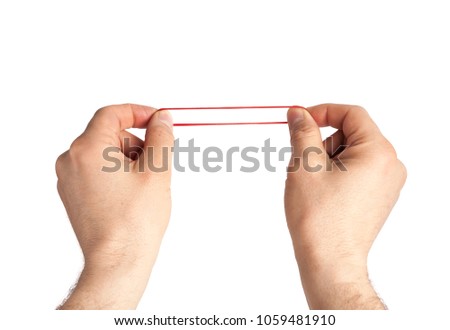 Red rubber band in hand. Elastic bands on hands.  dragging an elastic with hands. 