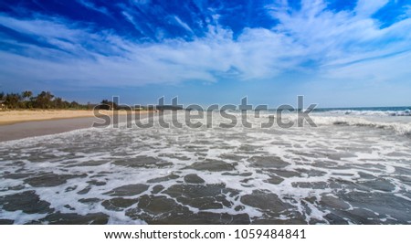 Beach front with water waves on a summer day